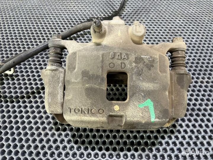 Суппорт тормозной лев. перед. Mitsubishi Triton