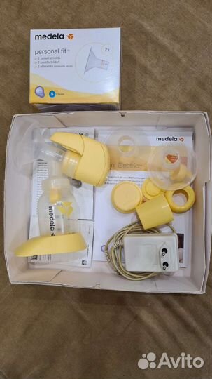 Молокоотсос medela и насадки новые