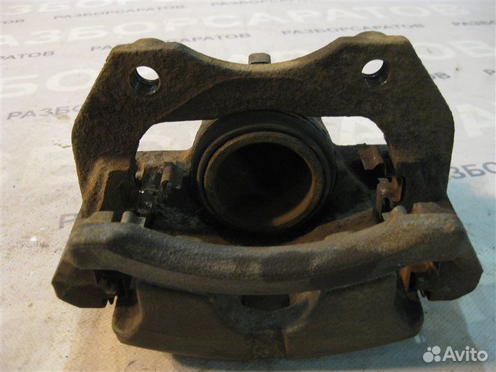 Суппорт тормозной передний левый Nissan Primera