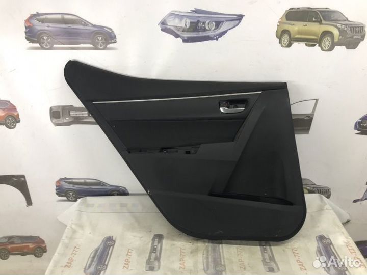 Обшивка двери задняя левая Toyota Corolla E180