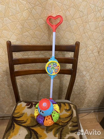 Детская игрушка каталка музыкальная