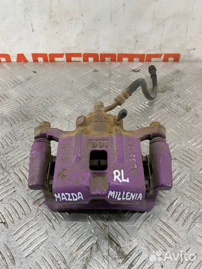 Суппорт тормозной задний левый Мазда Милления TA5P