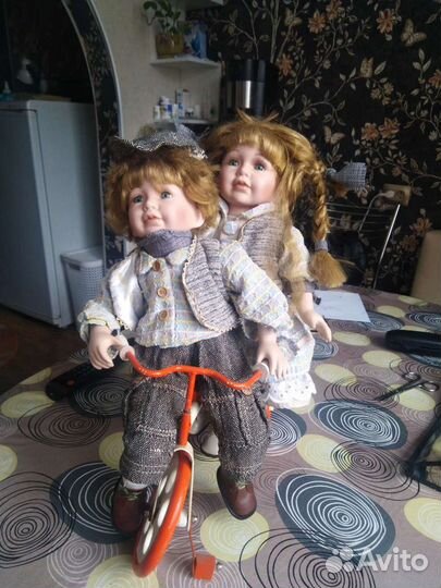 Пара фарфоровых кукол на велосипеде