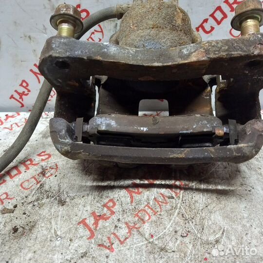 Суппорт тормозной передний Mitsubishi Lancer 9