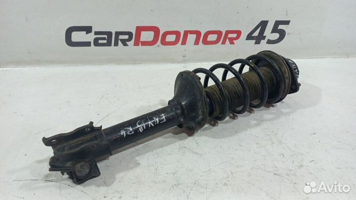 Амортизатор в сборе задний левый б/у для Nissan Bl