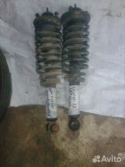 Стойки пер. в сборе на Сан Енг Кайрон 2.3 АКПП 13г